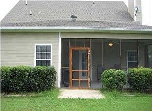 Flat backyard with screened in patio