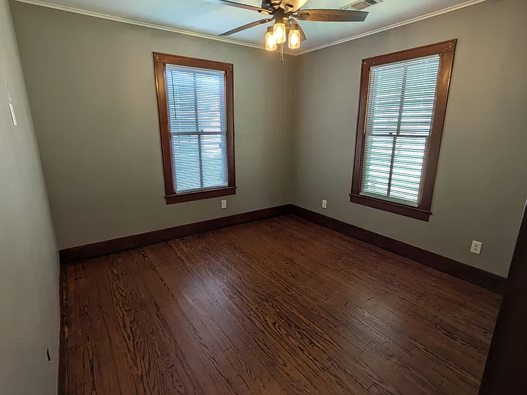 Bedroom 2 with original hardwood floors and beautiful windows. Bedroom is 12' x 13' and fits a king bed.