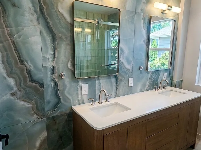 Upstairs bathroom with double vanity, custom tile statement wall.