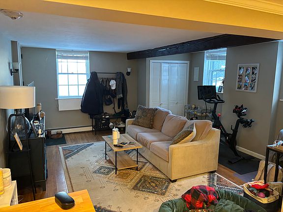 living room with private entrance and windows on 2 sides