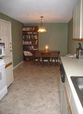 The kitchen has linoleum flooring and an abundance of counter space.