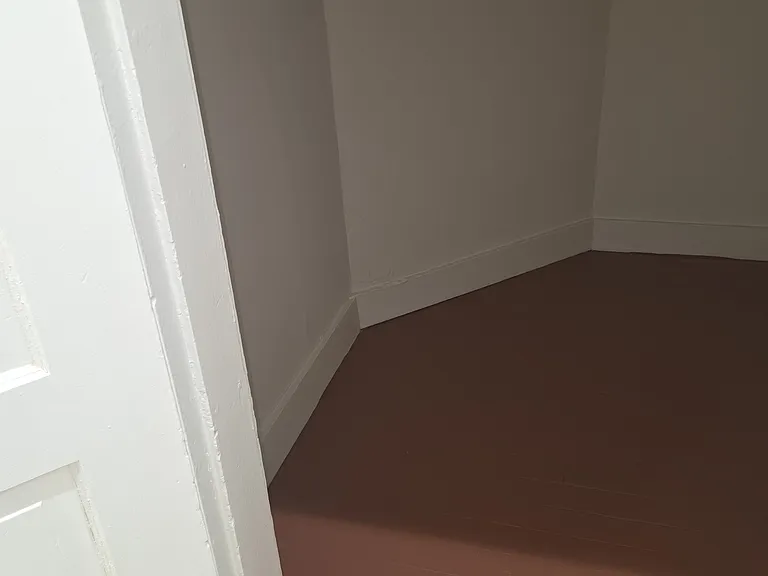 Small low height storage room off the main hallway.