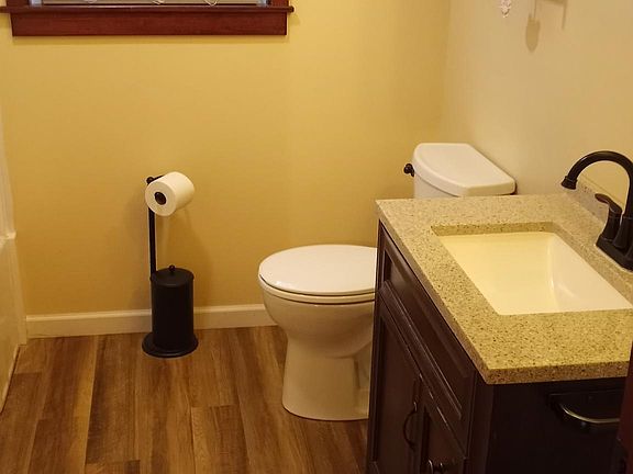 Spacious bathroom with room for storage, shower tub with new fixtures