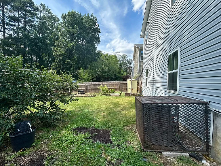 The spacious backyard is fully fenced all around for privacy and has well-kept green grass. Lawn maintenance is included.