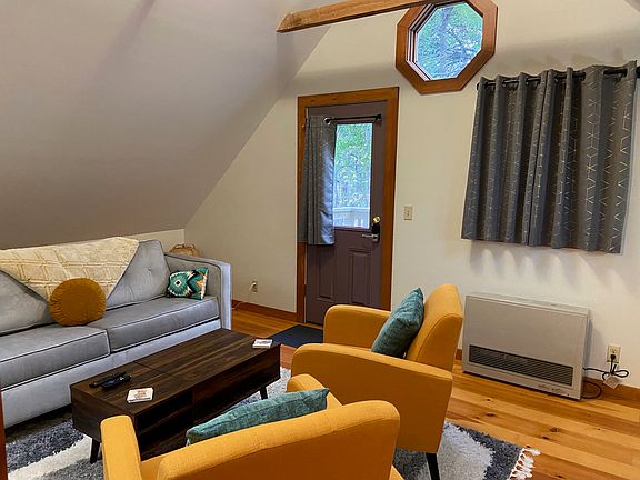 Livingroom with exterior door to small back porch and stairs to backyard