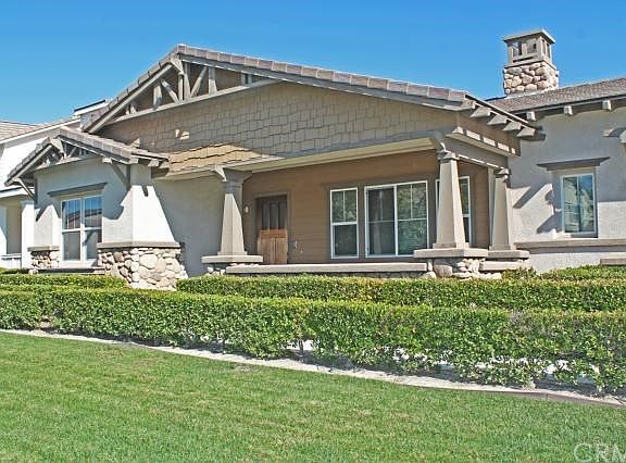 Stone accents and hedge lined entry path