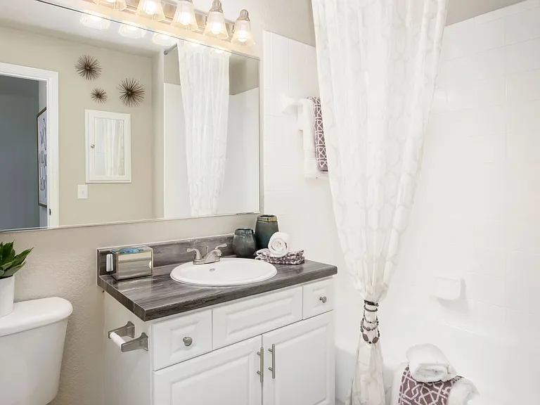 Revitalize your morning routine in our upgraded bathrooms, adorned with striking black fusion countertops and illuminating vanity lighting.