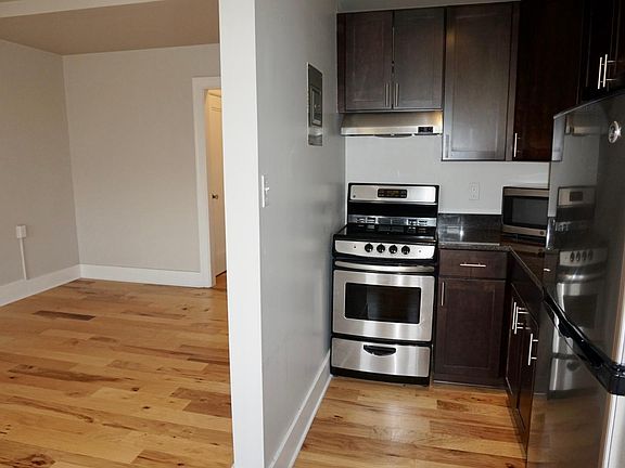 Kitchen with plenty of cabinet storage. Includes stainless steel refrigerator, stove, and microwave.