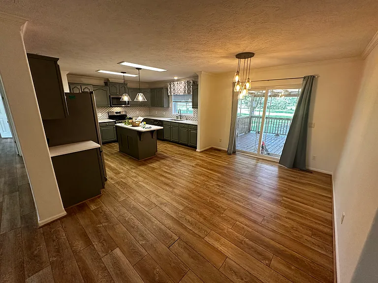 Eat in kitchen. Sliding back door to covered back porch, which leads to a fenced in 1 acre backyard.