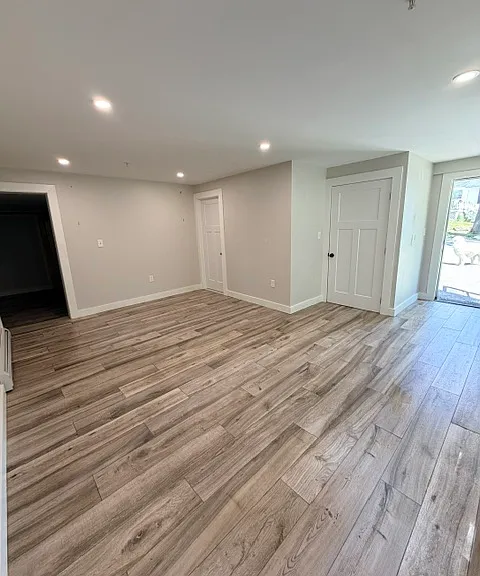 Living room (far left door goes to the bathroom, middle door is the in-unit washer and dryer, far right door is the front entrance to the unit)