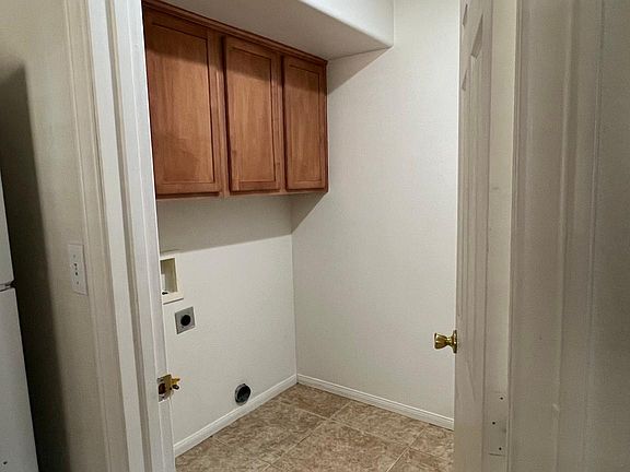 Dedicated Laundry Room with Electric and Gas Hookup and Cabinets for Additional Storage