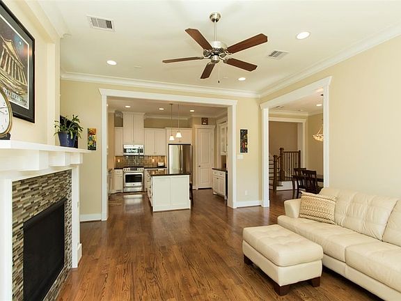 View from den to kitchen with adjacent dining room