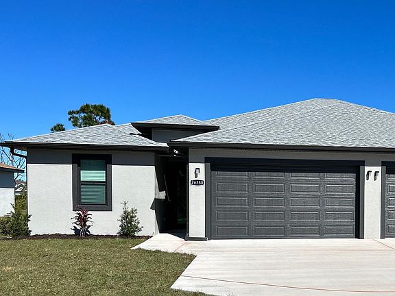 The unit is separated by a spacious 2 car garage and ample parking space.