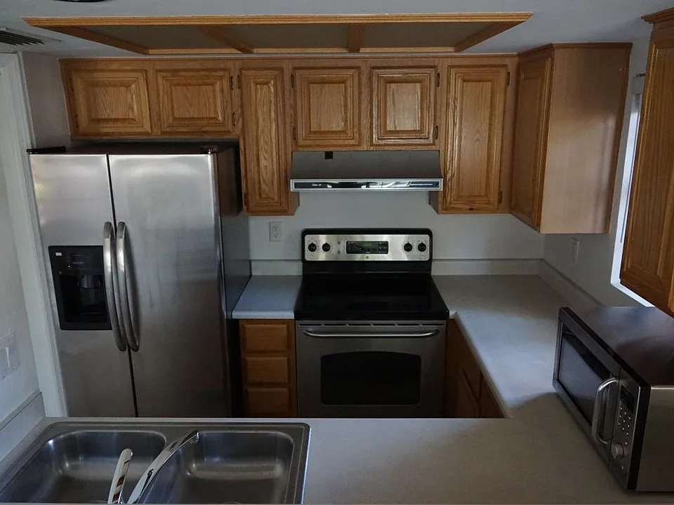 Close up of Kitchen with stainless steel appliances. (Matching dishwasher beside sink)