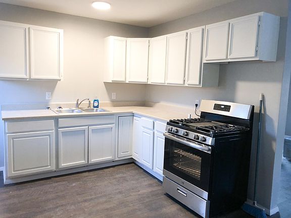 Fresh kitchen with new stainless steel range with gas burners and griddle