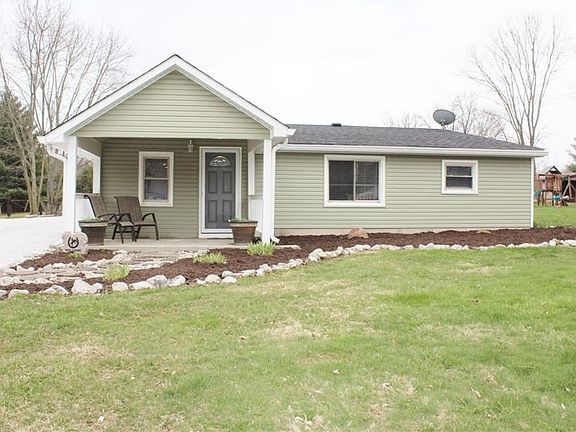Home has a covered front porch and nice landscaping.