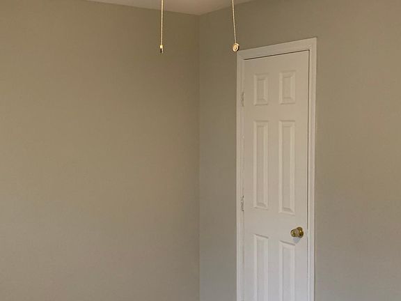 First bedroom with ceiling fans, hardwood flooring throughout and huge closets featuring two inch wooden blinds