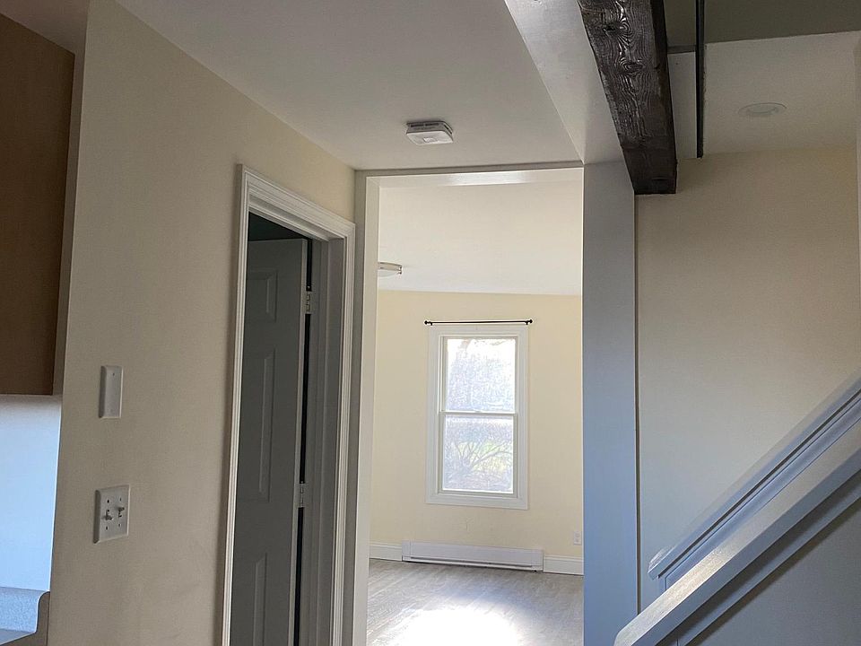 View from front door with kitchen on left and bathroom in the left door with living room straight ahead