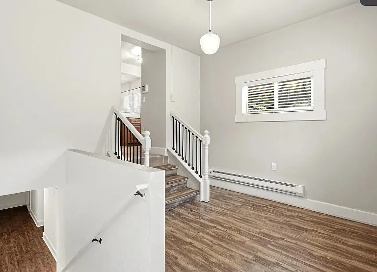Unfurnished office space down from the kitchen and above the basement. Same room as the back door and the laundry room.
