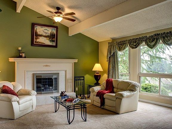 Bay Window Compliments this Beautiful Living Room with Open Beam Vaulted Ceilings and Dramatic Fireplace!!