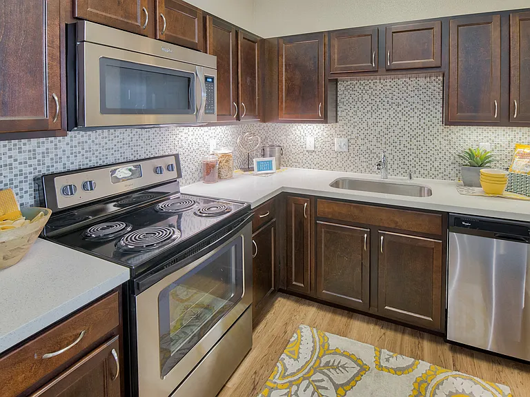 Our designer kitchens feature stainless steel appliances and quartz or granite counters
