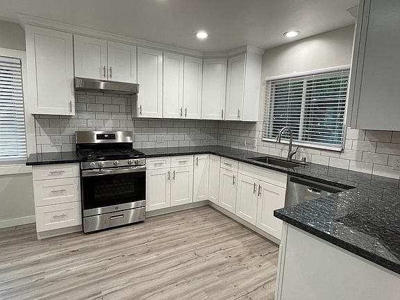 Newly remodeled kitchen with gas stove and dishwasher.