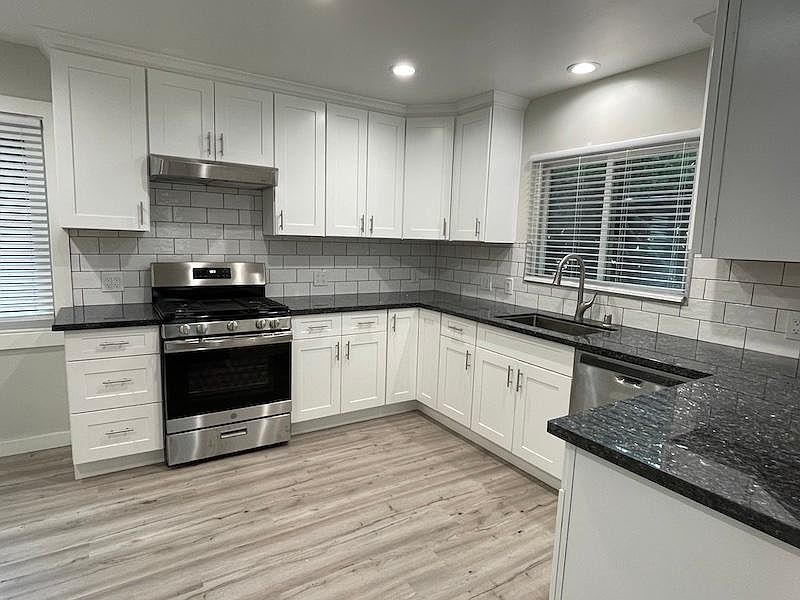 Newly remodeled kitchen with gas stove and dishwasher.