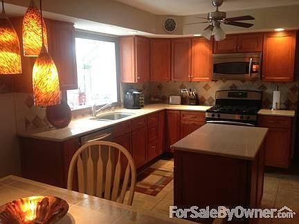 Bay window in living room
						:
						custom window treatments