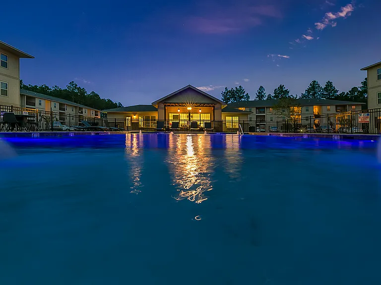 Swimming pool and clubhouse at night