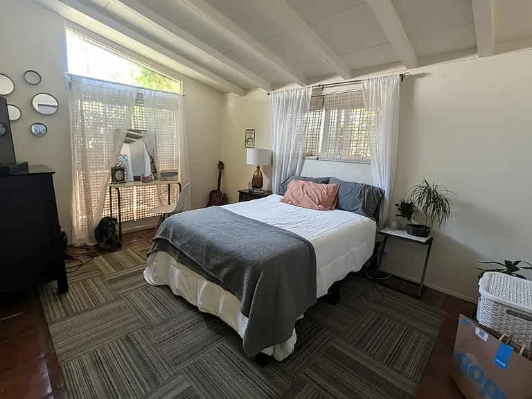 Room shown with some of current roommate's belongings in it.