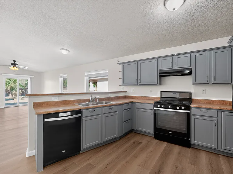 Spacious kitchen with open concept to the living room and dining space. Full kitchen amenities with dish washer, Stove, oven and refridgerator/freezer with ice maker and ample counter space.