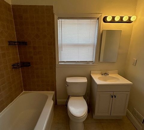 bath with ceramic tile floor and walls