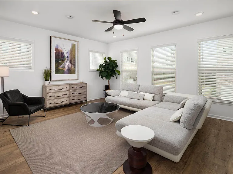Living room with large window letting in a ton of natural light.