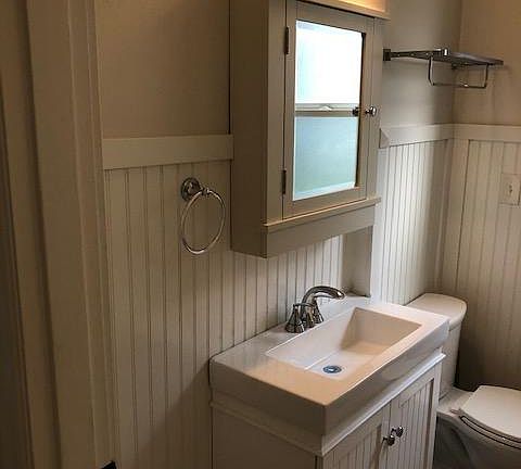 Bathroom on main floor--Rejuvenation fixtures. Claw foot tub and shower to the right