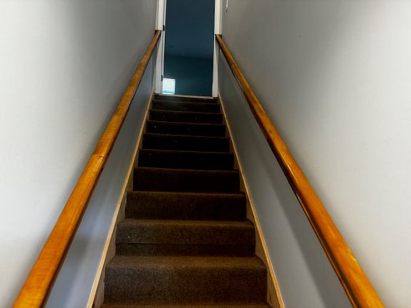 Private stairway from 1st floor exterior door to upper level entrance