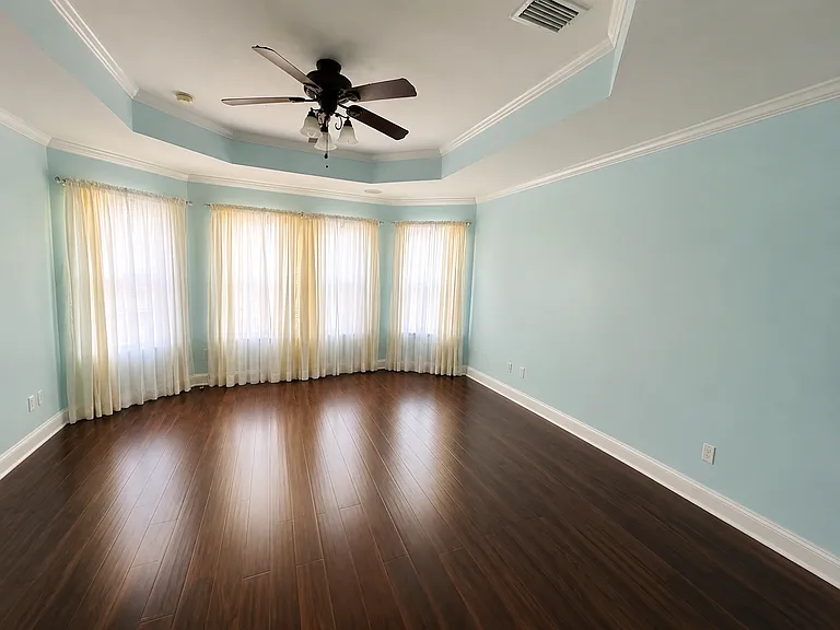 Large Master Bedroom. Fits a King size bed with two large nightstands and plenty of space for a recliner chair as well. Lots of windows overlooking the backyard.