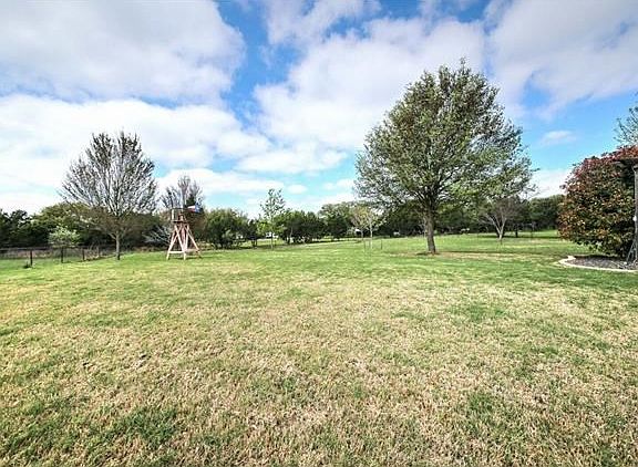 .99 acres of pure fun! Trees throughout the yard and lush landscaping as well. Upgraded celebration grass and automatic sprinklers with 19 zones and rain sensors are in the front and back of this home!