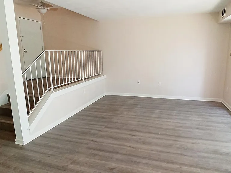 Grand entrance and spacious living room that measures 12 ft. x 12 ft.