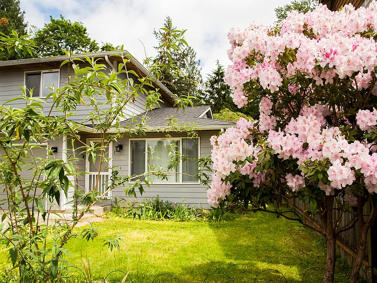 Front exterior with mature landscaping and a peaceful end-of-street setting. Large yard with plenty of outdoor space to enjoy.