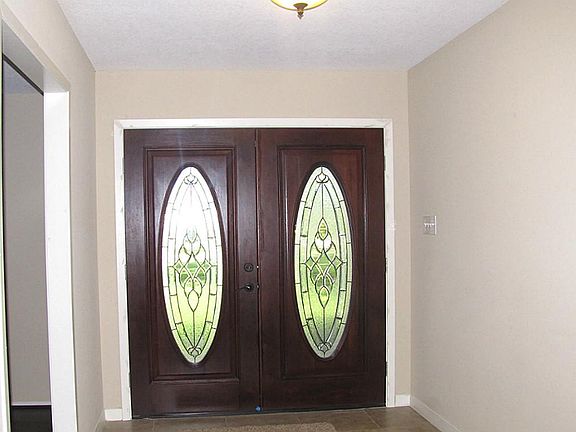 TILED ENTRY WITH GLASS & MAHOGANY DOUBLE FRONT DOORS