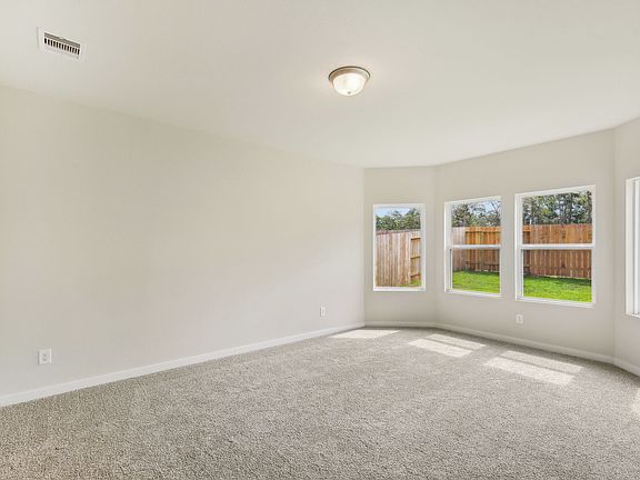 The primary bedroom of a home of Stewart s Ranch of Conroe, TX.