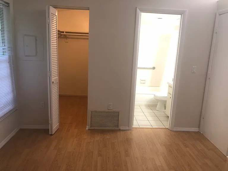 bedroom with view of bathroom and large walk in closet