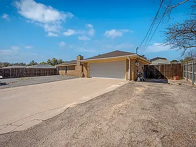 extra parking space uncovered next to large 2 car garage.