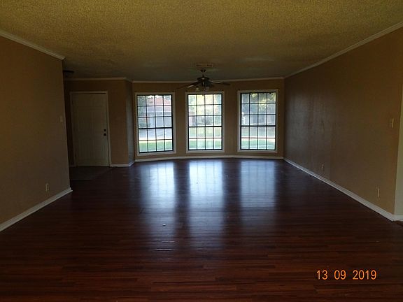 LOOKING FROM THE DINING ROOM TOWARDS THE LIVING ROOM AND FRONT ENTRANCE