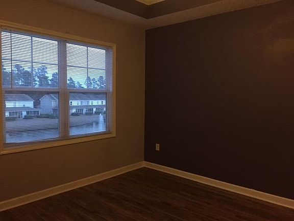larger master bedroom with view of pond