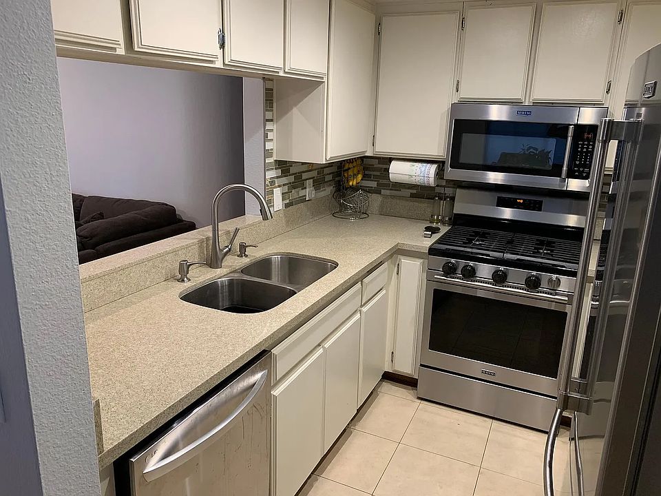 Kitchen with gas stove, microwave, fridge, and dishwasher