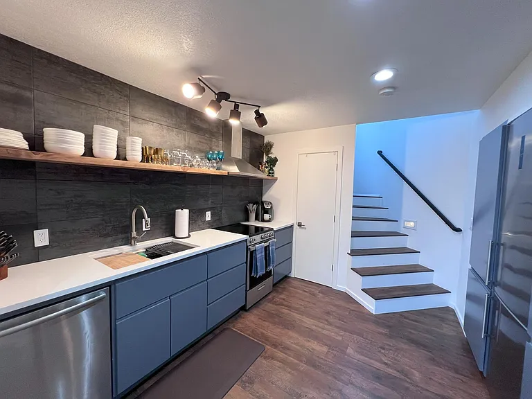 Fully-stocked custom kitchen features new tile and flooring