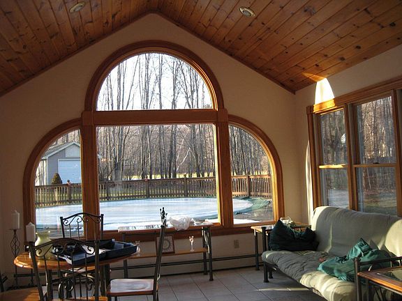 Sunroom with with vaulted wood ceiling.