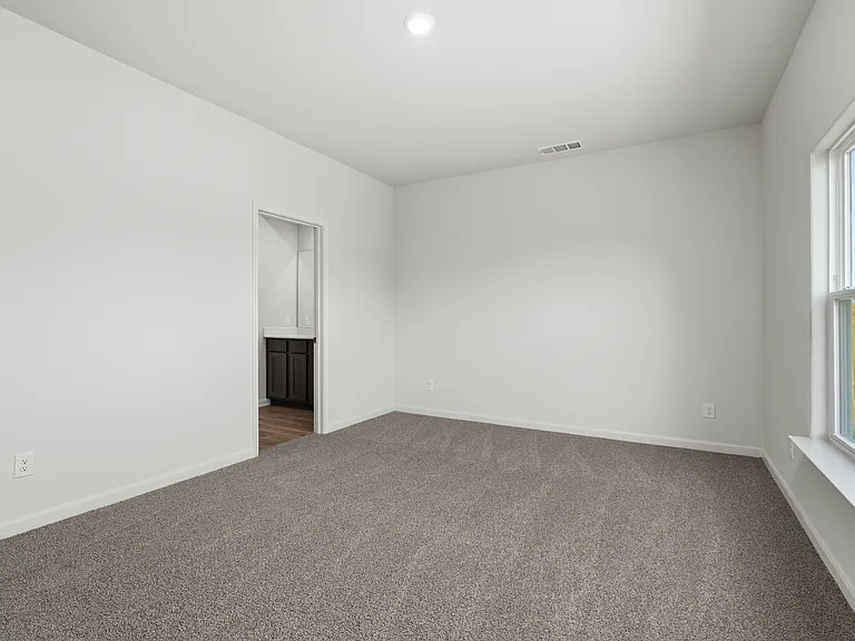 The master suite has a large bedroom, ensuite bathroom and a walk-in closet.