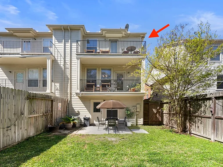 Backyard. Master bedroom includes private third floor balcony. Furnishings are staged.